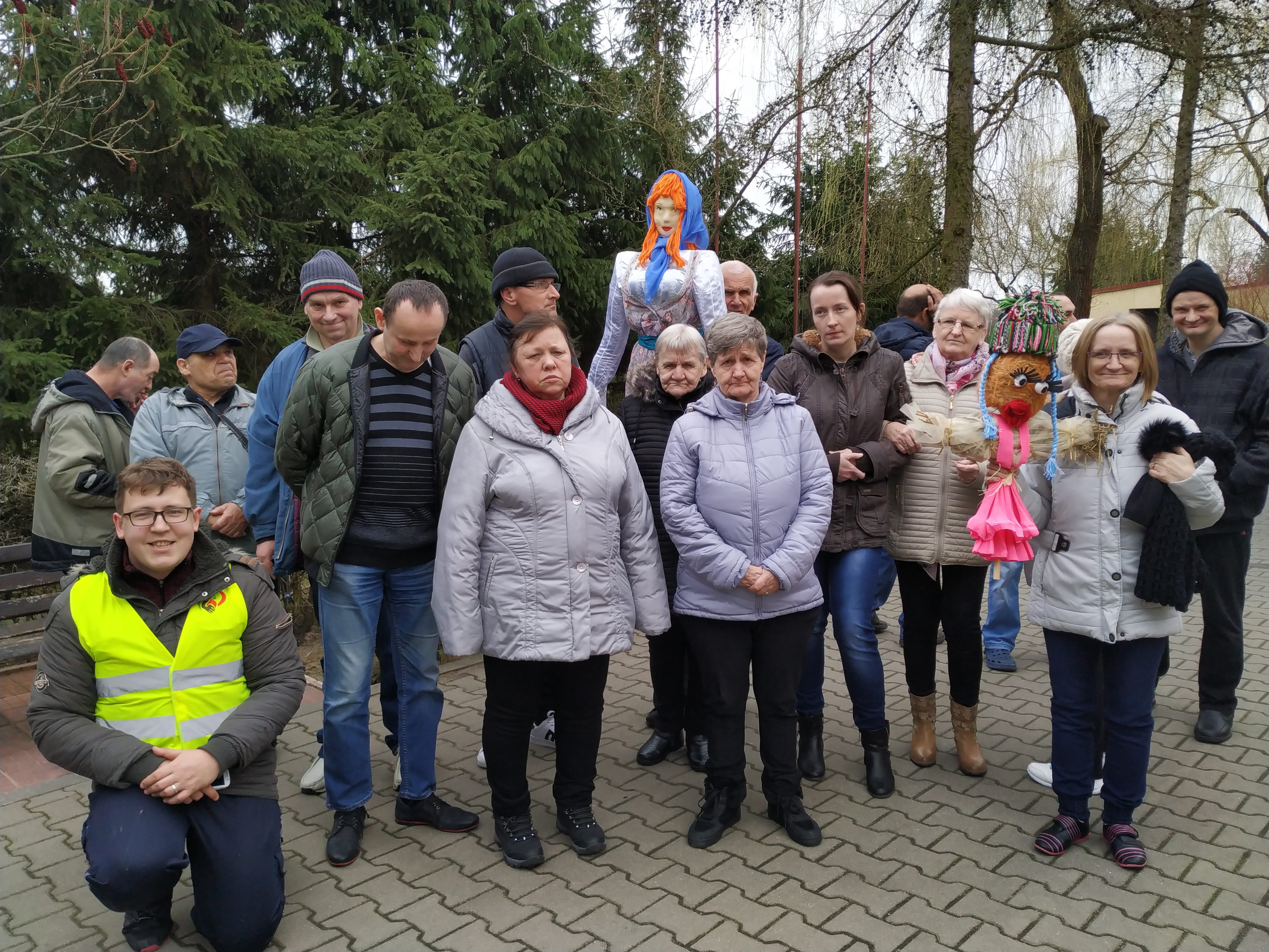 Stojący w grupie mieszkańcy Domów Pomocy Społecznej w Chojnie i Nowej Wsi pozują do zdjęcia z kukłami Marzanny.